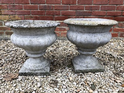 Lot 537 - A pair of concrete urns, each approximately...