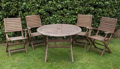 Lot 539 - A modern circular teak folding garden table...