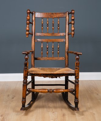 Lot 64 - A Lancashire elm spindle back rocking chair...