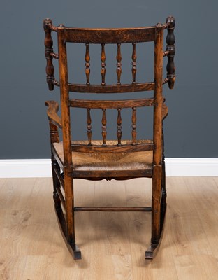 Lot 64 - A Lancashire elm spindle back rocking chair...