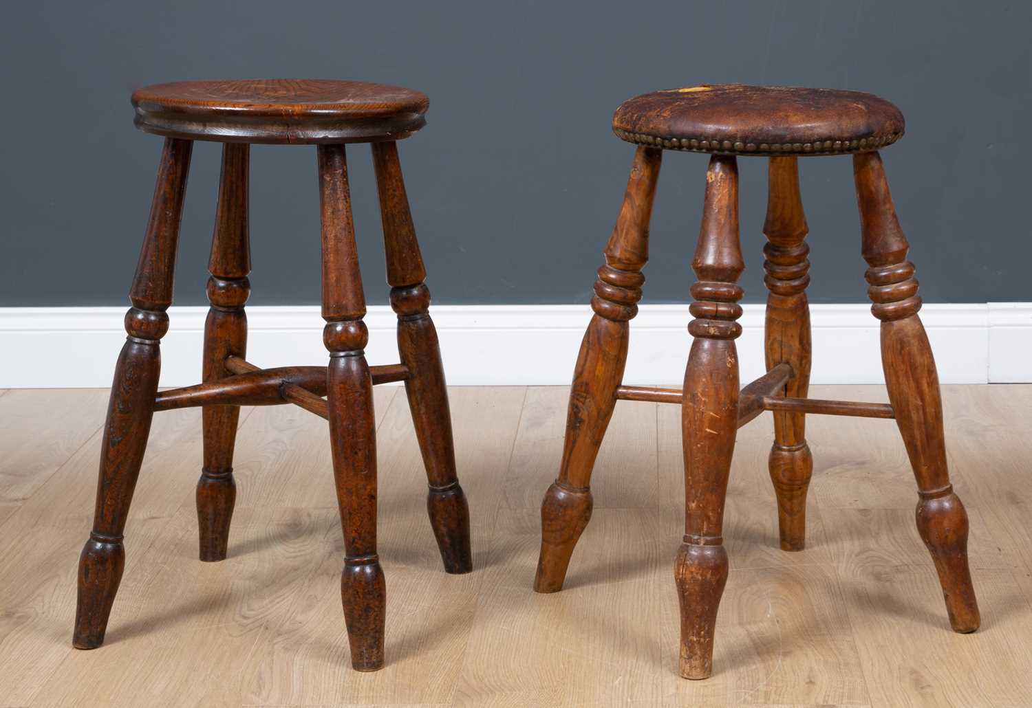 Lot 66 - An antique turned elm stool with dished top,...