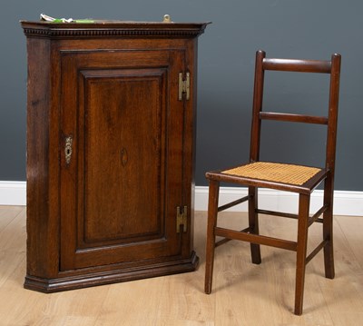 Lot 265 - A George III oak corner cupboard with single...