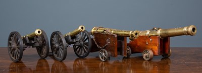 Lot 399 - A brass cannon with embossed shield and cross...