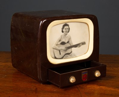 Lot 85 - A 1950's Bakelite TV wind-up music box, the...