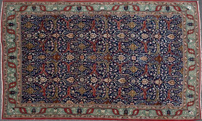 Lot 498 - An Oriental blue ground floral rug with green...