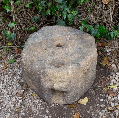 Lot 658 - An ancient gritstone quern with mask...