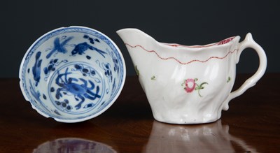 Lot 157 - A relief moulded cream jug with flower sprig...
