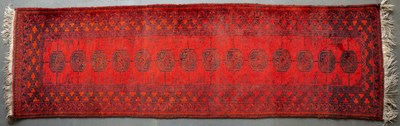 Lot 613 - A late 20th century Bokhara red ground rug...