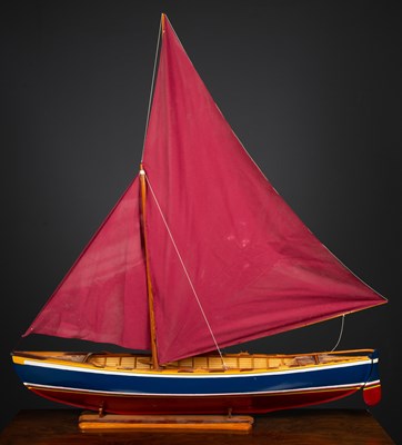 Lot 22 - A model sailing boat on stand, the blue and...