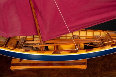 Lot 22 - A model sailing boat on stand, the blue and...