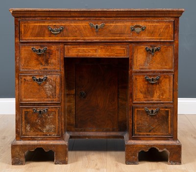 Lot 228 - A George II walnut and featherbanded kneehole...