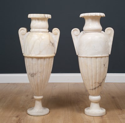 Lot 178 - A pair of alabaster lamps formed as classical...