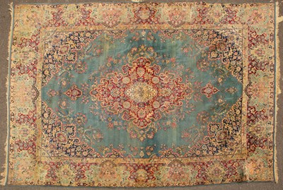 Lot 88 - An old Kirman light blue ground carpet with...