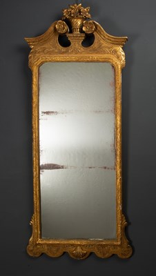 Lot 182 - A giltwood carved wall mirror, with broken...