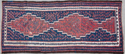 Lot 632 - A Kurdish red and blue ground kelim 271cm x 129cm