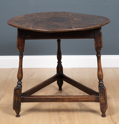 Lot 214 - An antique oak circular cricket table with a...