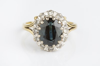 Lot 88 - A sapphire and diamond cluster ring, the oval...