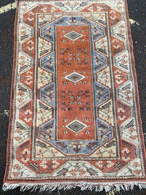 Lot 664 - A Turkish orange and cream ground woollen rug...