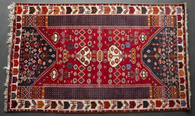 Lot 660 - A Middle Eastern red ground rug with...