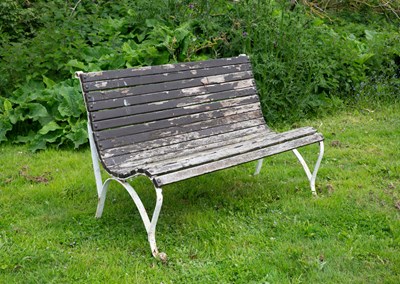 Lot 673 - A white painted wrought iron garden bench with...