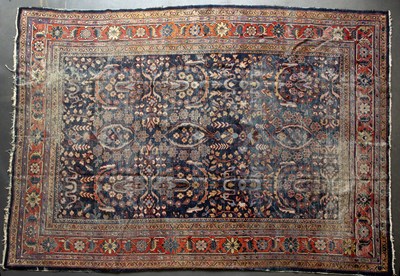 Lot 662 - A Persian blue and red ground rug with a...