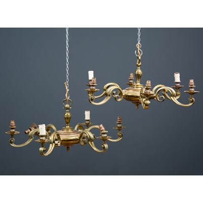 Lot 194 - A pair of brass six branch chandeliers, the...