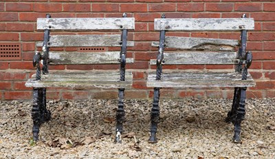 Lot 558 - A pair of cast iron framed garden chairs, the...