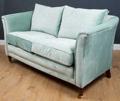 Lot 95 - A modern blue upholstered two-seater sofa, the...