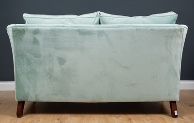 Lot 95 - A modern blue upholstered two-seater sofa, the...