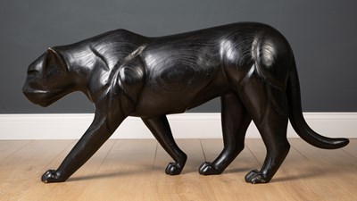 Lot 192 - A carved wooden and ebonised black panther...