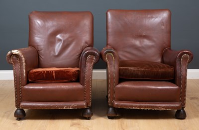 Lot 353 - A pair of brown leather armchairs, the...