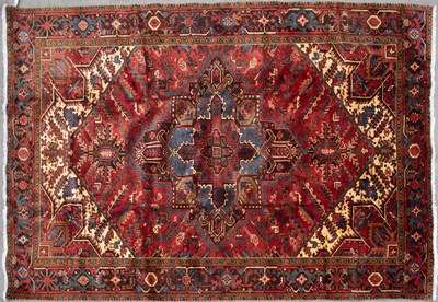 Lot 669 - A Middle Eastern Heriz red ground rug with...