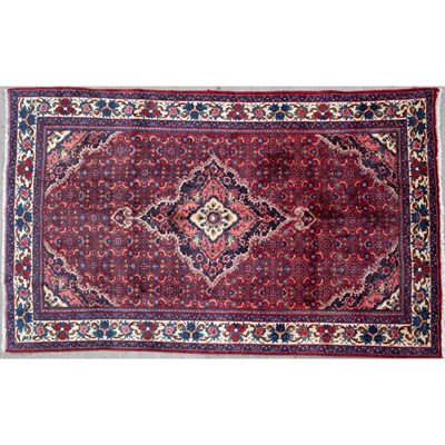 Lot 672 - A Middle Eastern blue and red ground rug 205cm...