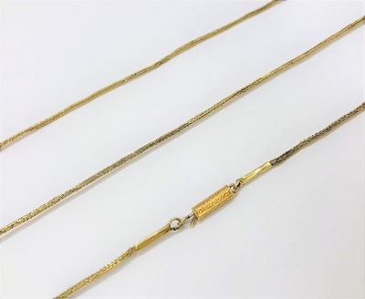 Lot 30 - A yellow precious metal long chain, of plaited-...