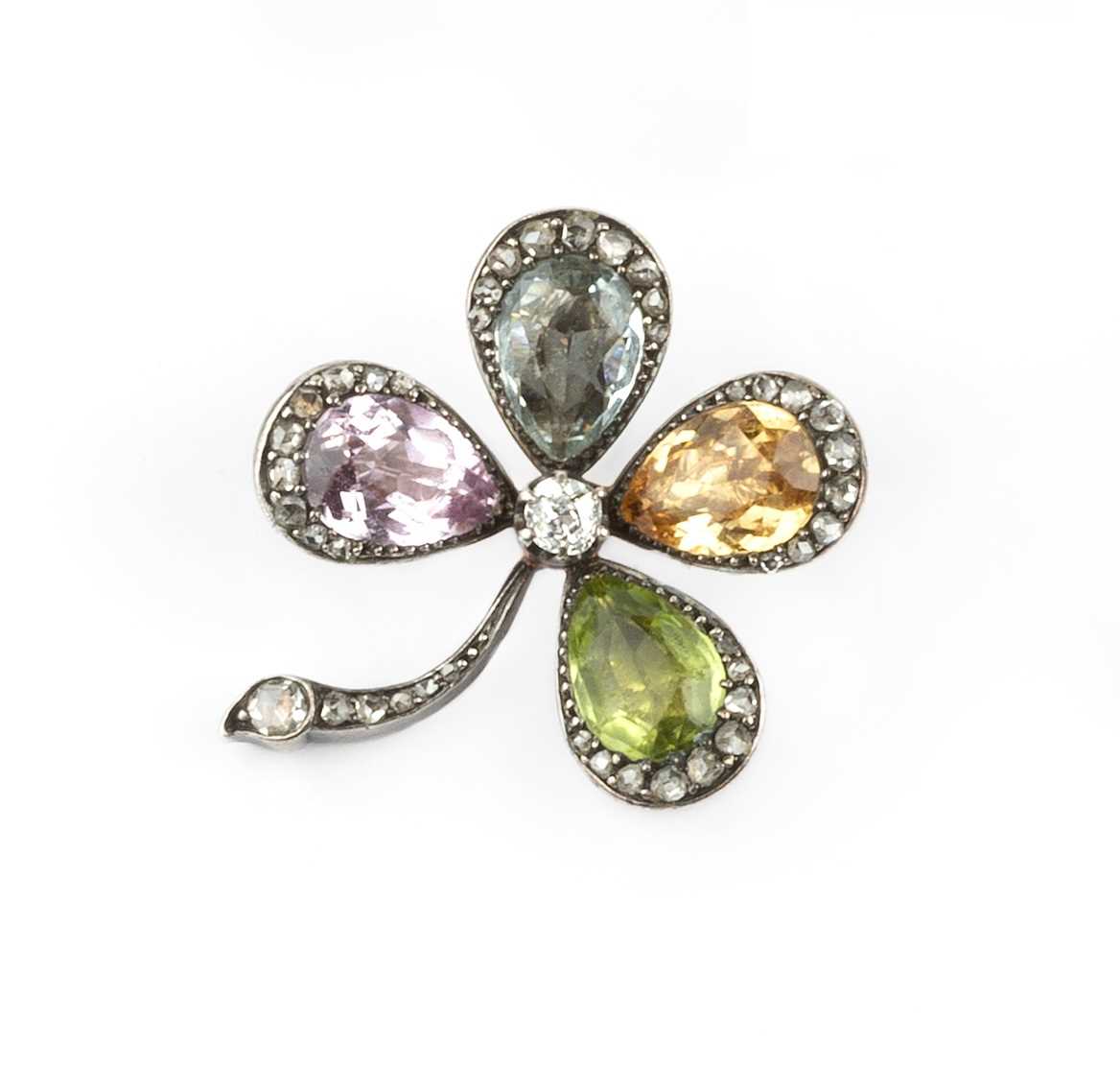 Lot 121 - A diamond and gem set four leaf clover brooch,...