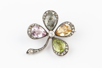 Lot 121 - A diamond and gem set four leaf clover brooch,...