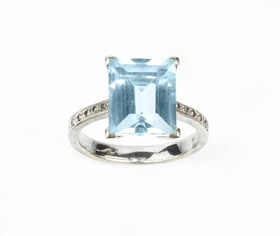 Lot 180 - A blue topaz and diamond dress ring, the...