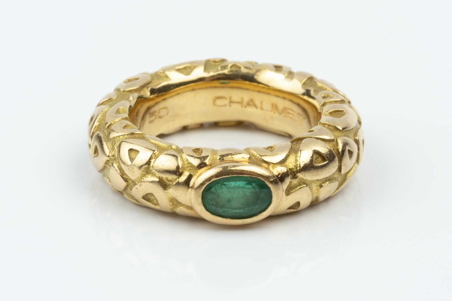 Lot 165 - An emerald set band ring by Chaumet, decorated...