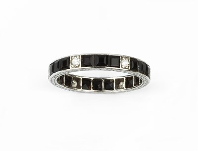 Lot 181 - A diamond and gem set full hoop eternity ring,...