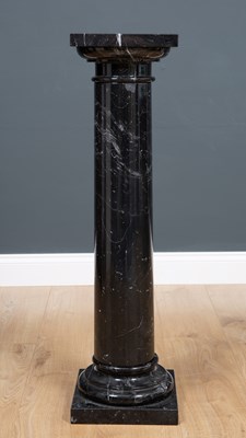 Lot 454 - A black marble pedestal on a column with...