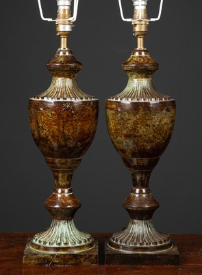 Lot 457 - A pair of bronzed table lamps formed as...