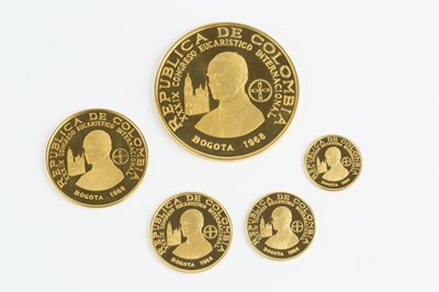 Lot 342 - A Republic of Colombia gold five coin set,...