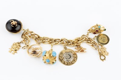 Lot 60 - A charm bracelet, the yellow precious metal...