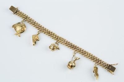 Lot 59 - A charm bracelet, the fancy double row...