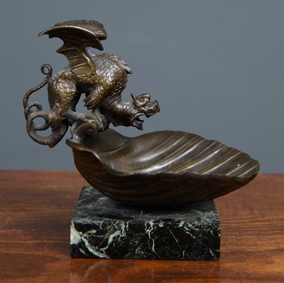 Lot 38 - A small bronze dish with a dragon perched on...