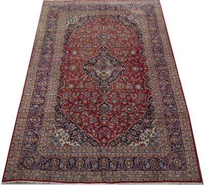 Lot 677 - An Eastern red, blue and green ground carpet...