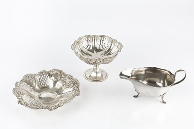 Lot 904 - A silver sauce boat, with shaped border, on...