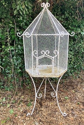 Lot 179 - A free standing white painted wirework...