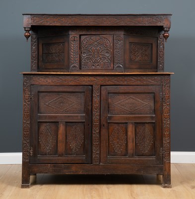Lot 137 - An antique oak court cupboard with carved...