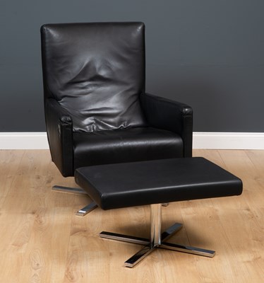 Lot 252 - A black leather upholstered rotating armchair...